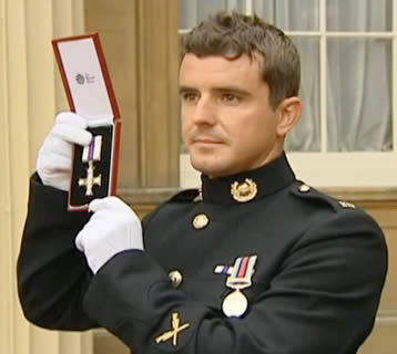Marine Craig Buchanan receives the Military Cross at Buckinham Palace