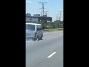 Taxi driving down South African motorway with no wheel and axel on fire
