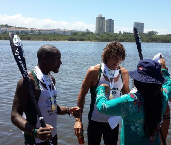Sbonelo Zondi and Andy Birkett receive their gold medals from the MEC for art, culture, sport and recreation, Ntombikayise Sibhidla-Saphetha, at the finish of the 2014 Dusi Canoe Marathon at Blue Lagoon in Durban. (Image: Lucille Davie)