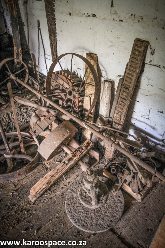 Centuries-old farm implements lie rusting in the corner.