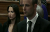 Oscar Pistorius in court today (with his sister in the background)