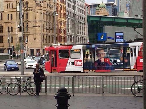 An advert for Troye's YouTube channel appears on the side of a tram in Melbourne, Australia