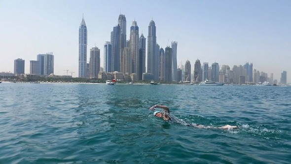 Kieran nearing finish strait - Dubai Marina in background with tallest residential towers in the world.