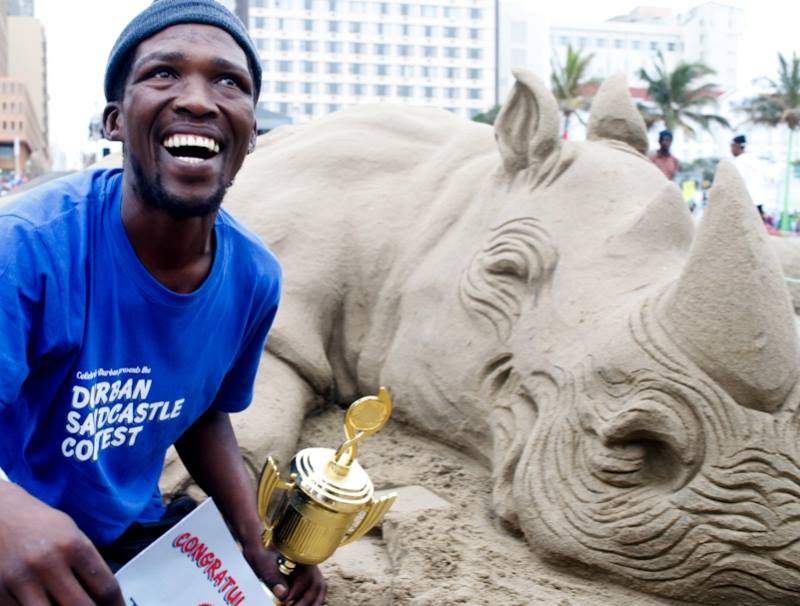 Durban sand artist with his winning rhino sculpture