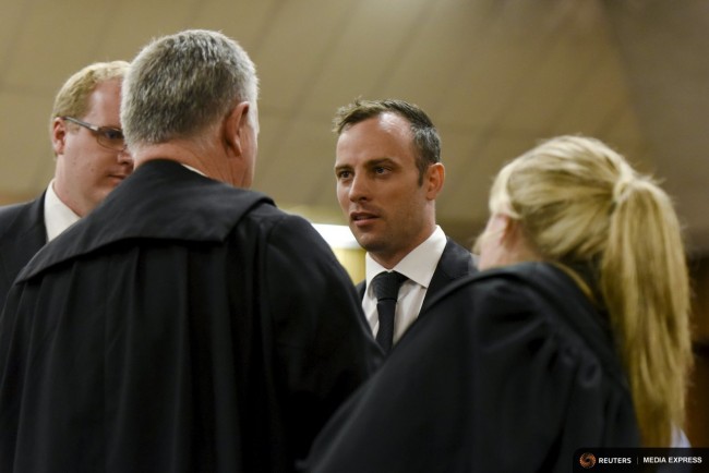 Oscar Pistorius speaks to his lawyer Barry Roux at the North Gauteng High Court in Pretoria, South Africa during a bail hearing December 8, 2015. REUTERS/Herman Verwey/Pool
