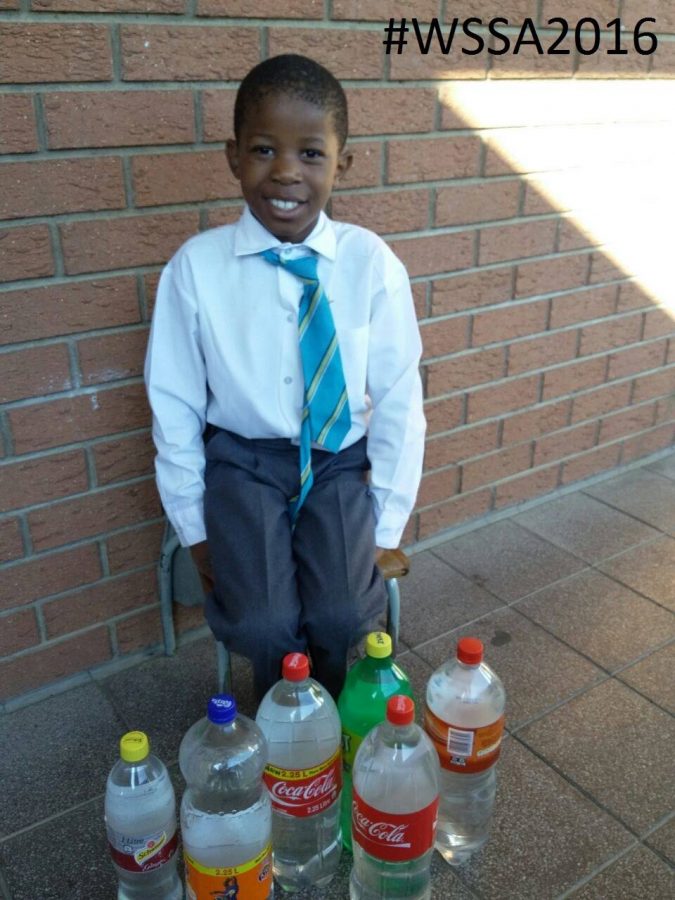 Young boy takes water to school