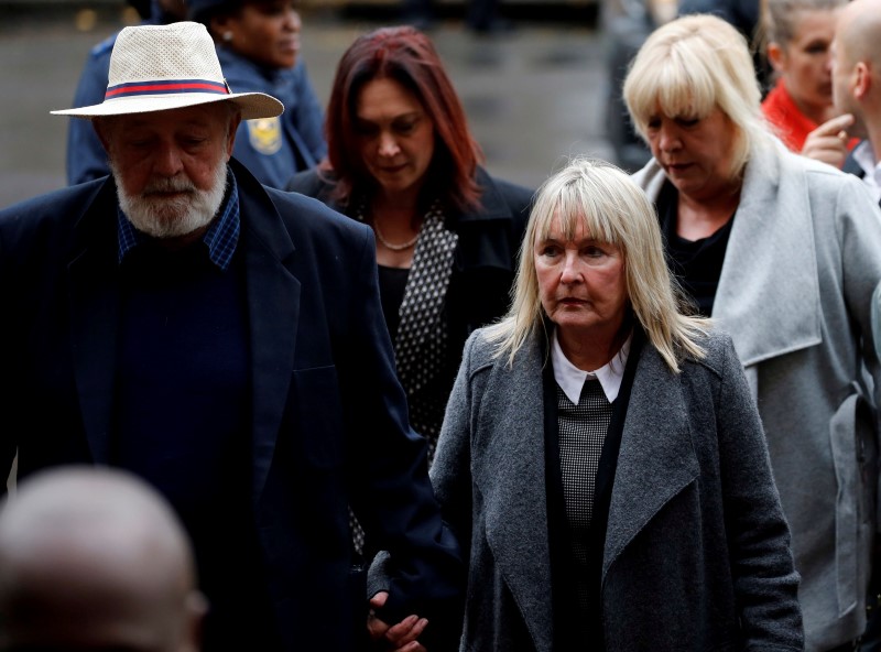Barry Steenkamp (L), father of Reeva Steenkamp, arrives with his wife June Steenkamp for the sentencing of former Paralympian Oscar Pistorius at the Pretoria High Court, South Africa June 13,2016. REUTERS/Siphiwe Sibeko