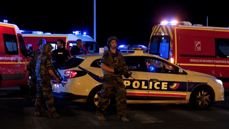 French soldiers and rescue forces are seen at the scene whare at least 30 people were killed in Nice, France, when a truck ran into a crowd celebrating the Bastille Day national holiday July 14, 2016.  REUTERS/Eric Gaillard