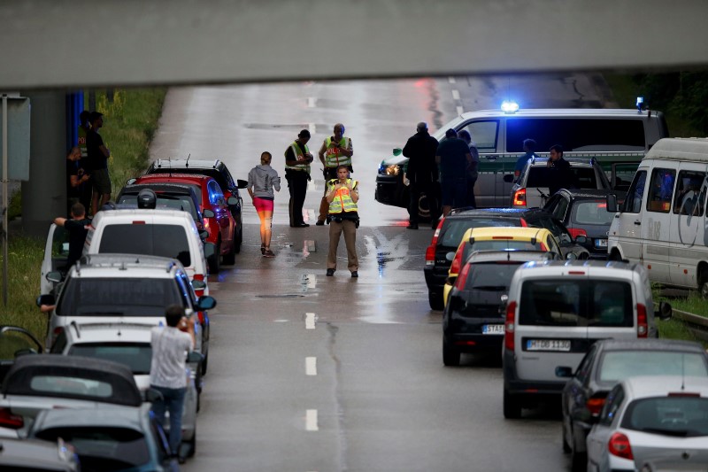 Police halt traffic on a road near to the scene of a shooting rampage at the Olympia shopping mall in Munich, Germany July 22, 2016. REUTERS/Michael Dalder
