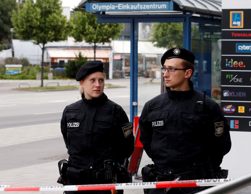 Policemen stand guard near the Olympia shopping mall, where yesterday's shooting rampage started, in Munich, Germany, July 23, 2016.   REUTERS/Michael Dalder