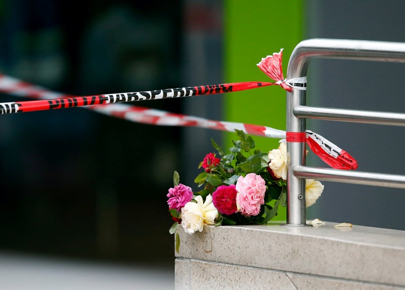 Flowers are placed near the Olympia shopping mall, where yesterday's shooting rampage started, in Munich, Germany July 23, 2016.   REUTERS/Michael Dalder