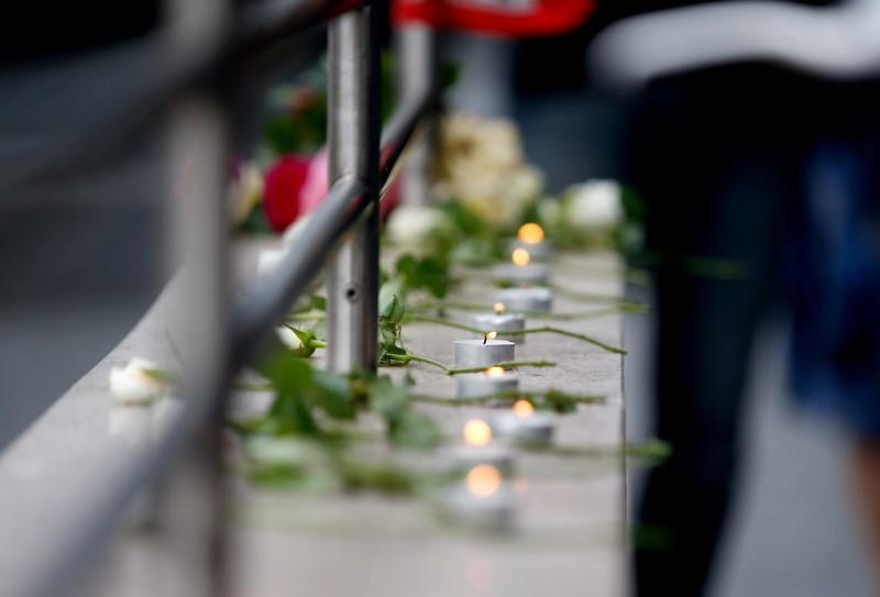 Candles are lit near the Olympia shopping mall, where yesterday's shooting rampage started in Munich, Germany July 23, 2016.   REUTERS/Michael Dalder
