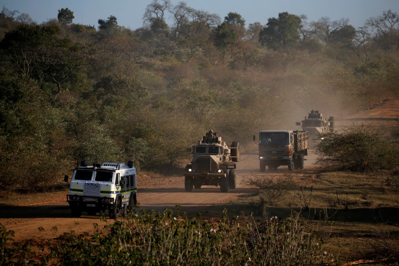 Members of the South African National Defence Force (SANDF) drive behind a police Nyala as they patrol a village during tense local municipal elections in Vuwani, South Africa's northern Limpopo province, August 3, 2016. REUTERS/Siphiwe Sibeko