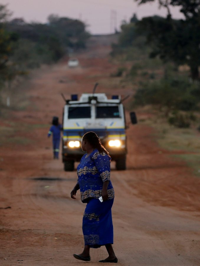 A woman looks on as a police Nyala patrols a village during tense local municipal elections in Vuwani, South Africa's northern Limpopo province, August 3, 2016. REUTERS/Siphiwe Sibeko
