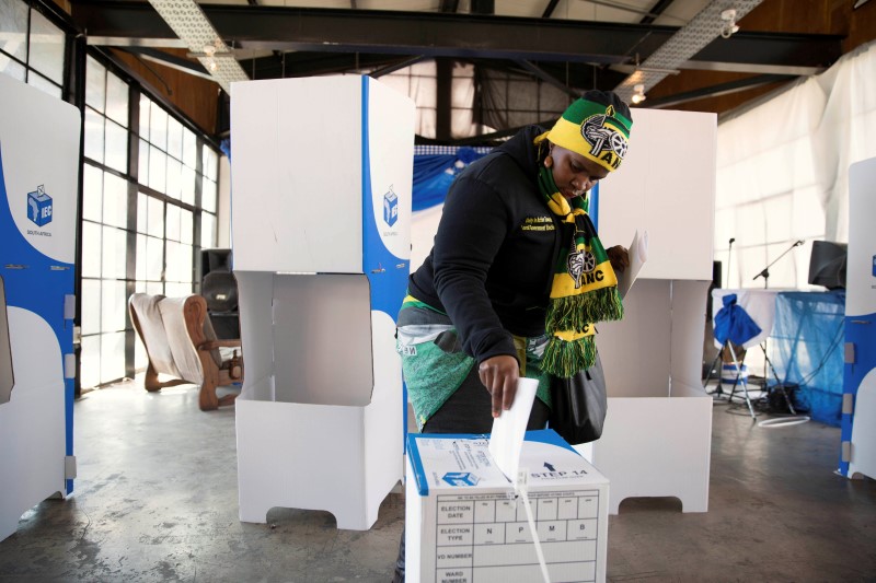 A women wearing ANC regalia casts her vote during the local government elections in Hillbrow, central Johannesburg, South Africa August 3,2016. REUTERS/James Oatway