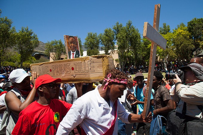 Protesters carry a "coffin" for Blade Nzimande. This was burnt and thrown at police. Photo: Ashraf Hendricks