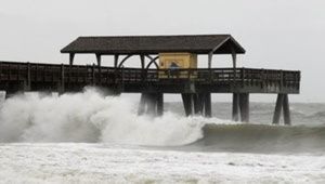 Waves pound the pier as Hurricane Matthew approaches on Tybee Island, Georgia, October 7, 2016. REUTERS/Tami Chappell