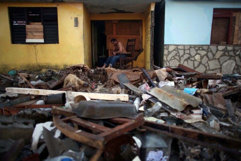 Lawyer Jorge Luiz Azanes, 52, sits in his damaged house after the passage of Hurricane Matthew in Baracoa, Cuba October 7, 2016. REUTERS/Alexandre Meneghini