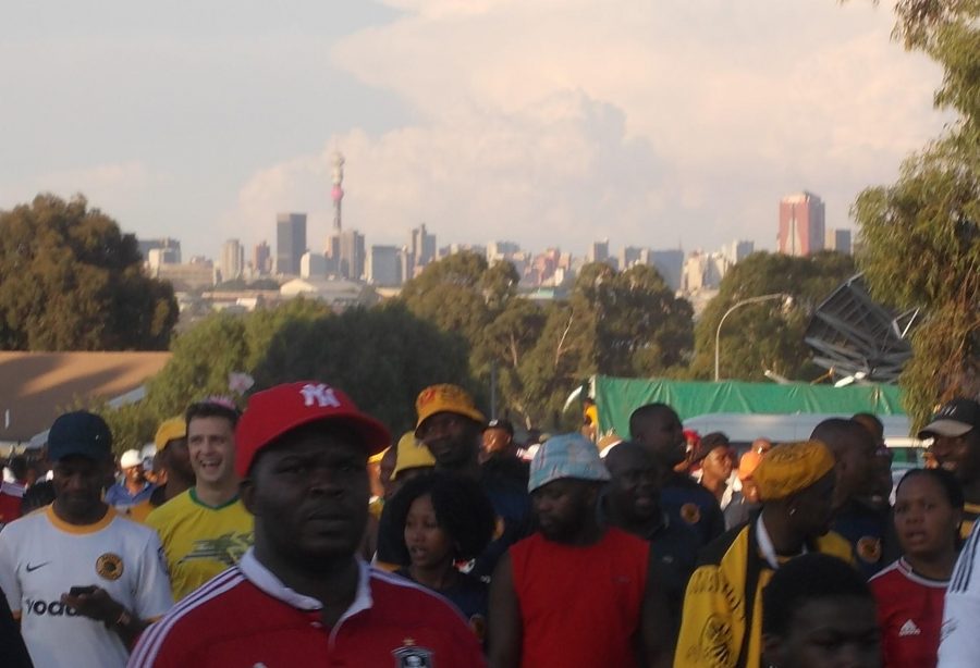 Fans Leaving Soccer City with skyline behind - Heritage Portal - 2016