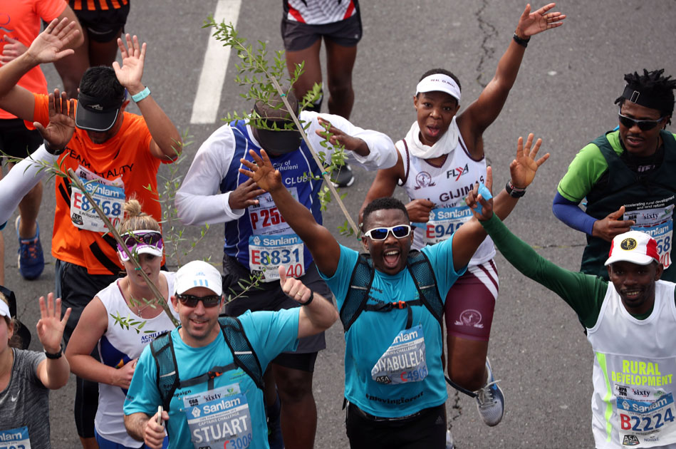 Activist and treegrower Sokomani celebrates as he approaches the final stretch of the Cape Town marathon