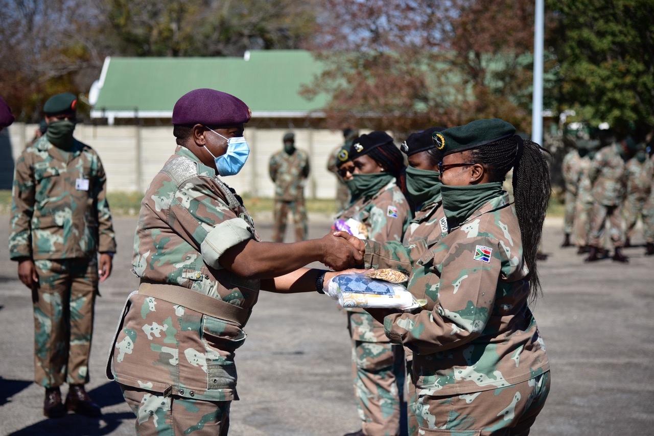 Lieutenant General R. Maphwanya handing over hygiene parcels to female officers, after which a near 324 female enlistees line up – Doornkop, Johannesburg.