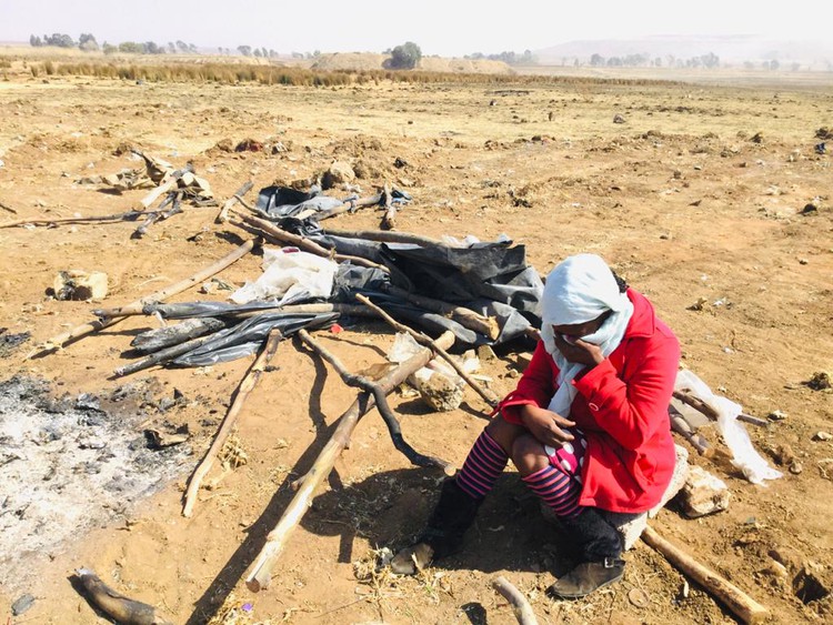 Thandeka Ngobeni sits next to what remains of her shack near the Heidelberg highway in Tsakane. It was demolished for a third time by metro police on Monday morning. Photo: Kimberly Mutandiro