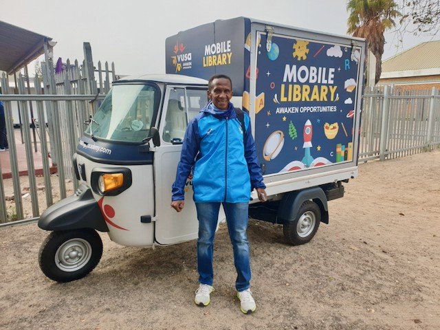 School children scream excitedly when they see this tuk-tuk arrive with Lungile Moferi, because they know he has come to read them a story from a book he will take from this mobile library which he drives around Langa. Photo: Mary-Anne Gontsana