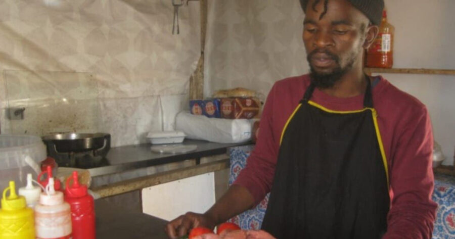 Lindokuhle Msomi from KwaMashu in Durban preparing a meal in the fast food stall he started after losing his job as an artist during lockdown last year. He says he was able to open his stall with the R350 Covid-19 grant he had been getting for nine months. Photo: Nokulunga Majola