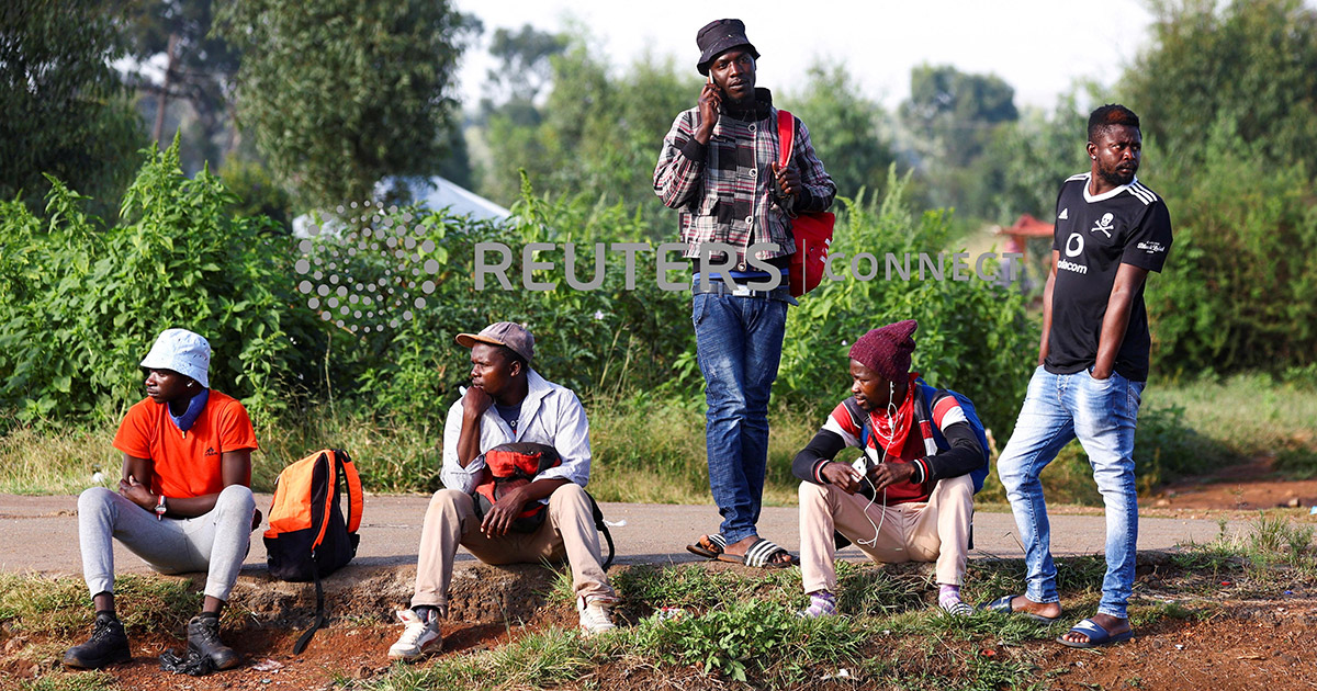 FILE PHOTO: Job seekers wait beside a road for casual work offered by passing motorists in Eikenhof, south of Johannesburg, South Africa, March 3, 2022. REUTERS/Siphiwe Sibeko/File Photo