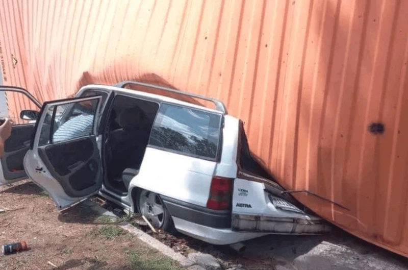 Driver miraculously walks away after truck container flattens car
