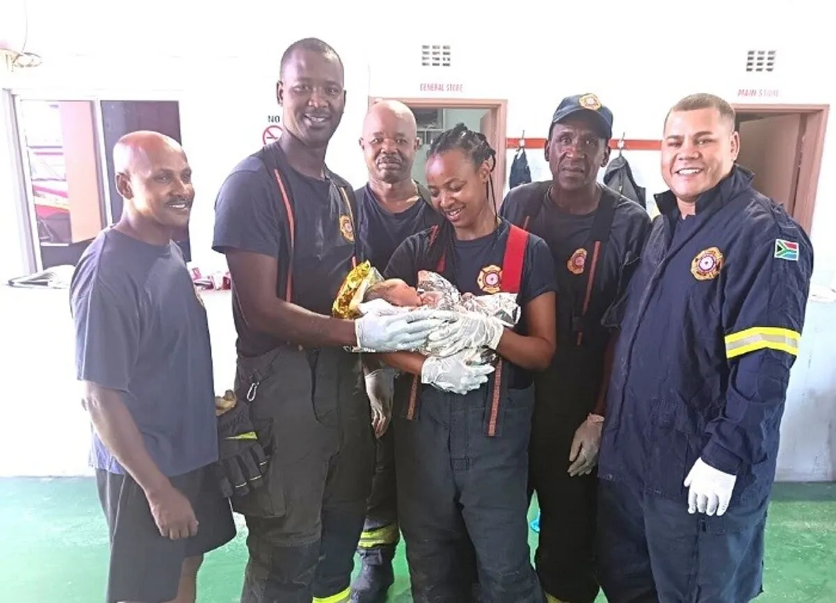 Mfuleni firefighters with the baby they helped deliver.