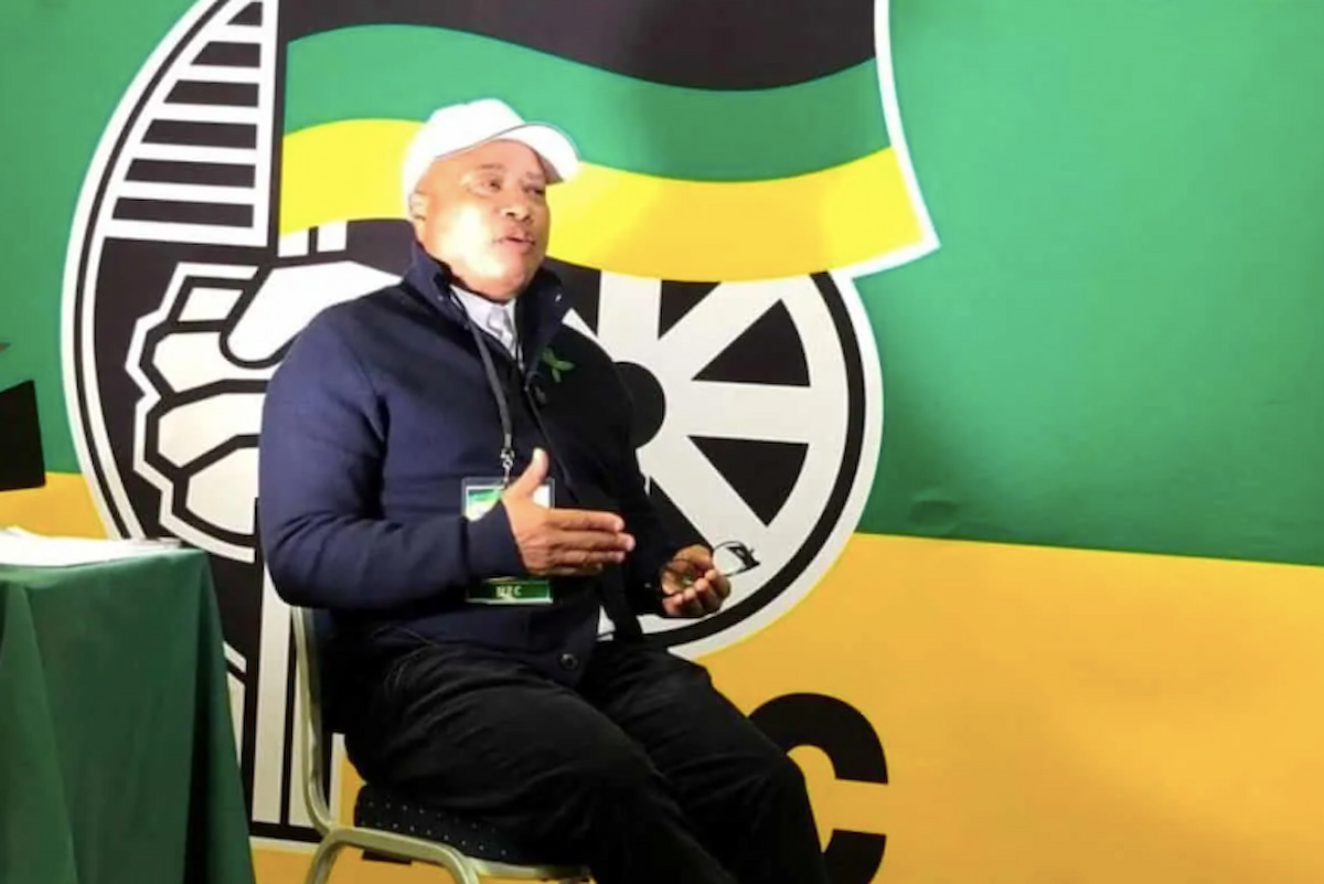 Tony Yengeni sitting in front of an ANC logo Tony Yengeni profile