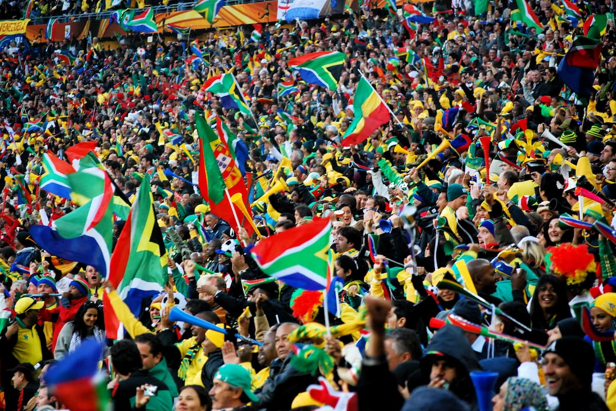 South African fans at the first match (Mexico vs South Africa) of the 2010 FIFA World Cup at Soccer City. This image accompanies an article about South Africa weighing up a bid for the 2036 or 2040 Olympic Games.