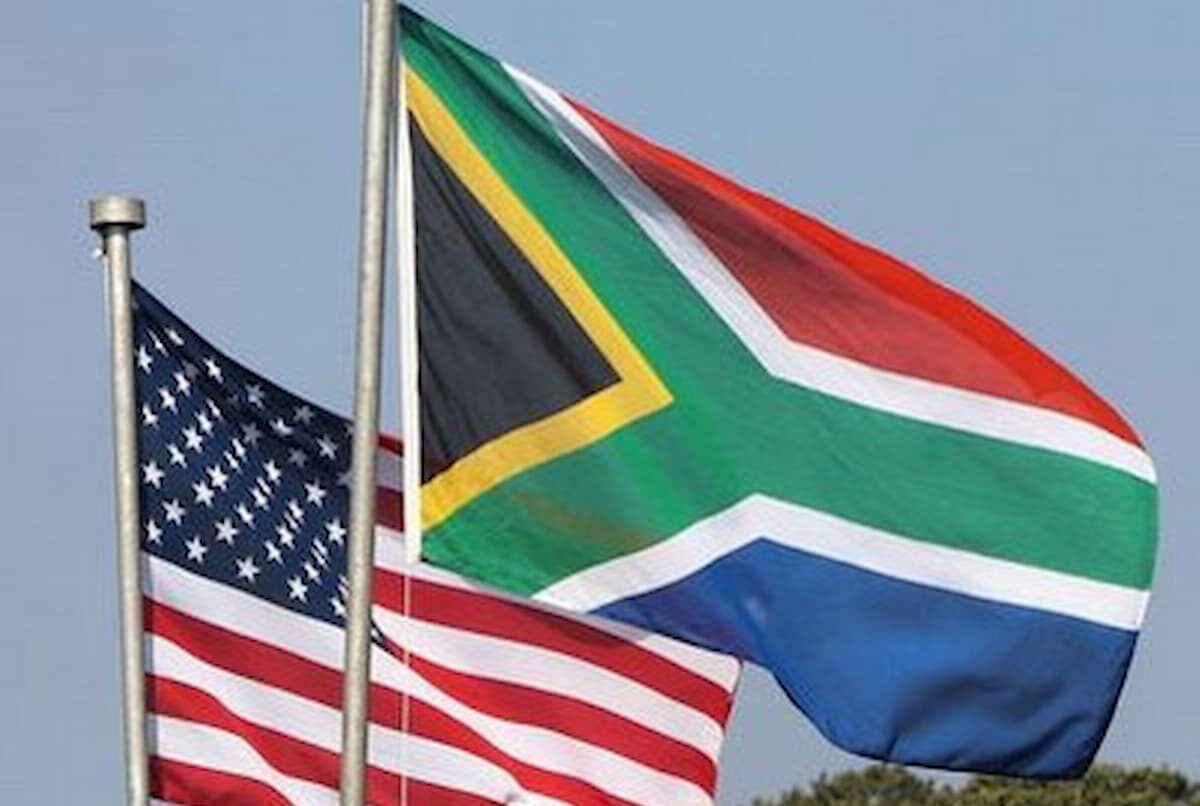 Image of the South Africa and United States flags flying next to each other. This image accompanies an article about the United States threatening South Africa over personnel harassment