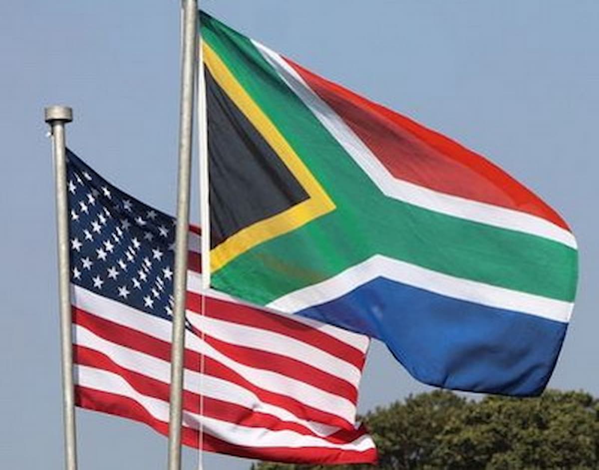 Image of the South Africa and United States flags flying next to each other. This image accompanies an article about the United States threatening South Africa over personnel harassment