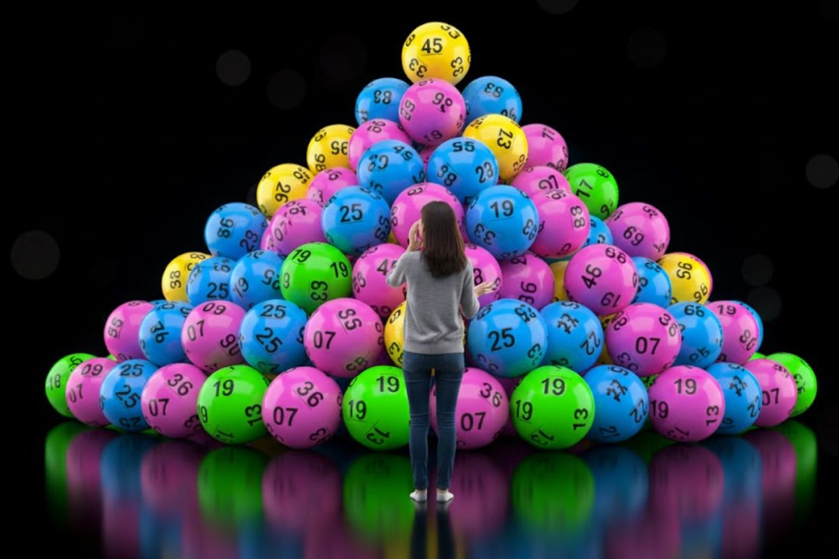 a Person infront of lotto balls wondering what numbers to choose.